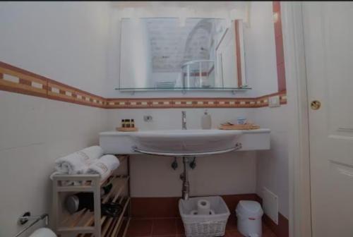 a bathroom with a sink and a mirror at Saymon's Suite in Ceglie Messapica