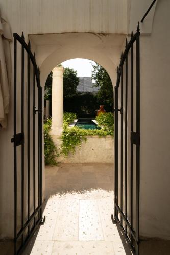 an entrance to a house with an open gate at Palazzo Muci in Nardò