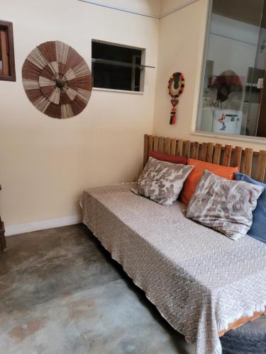 a bedroom with a bed and a fan on the wall at Pousada Pico Da Vila in Vale do Capao