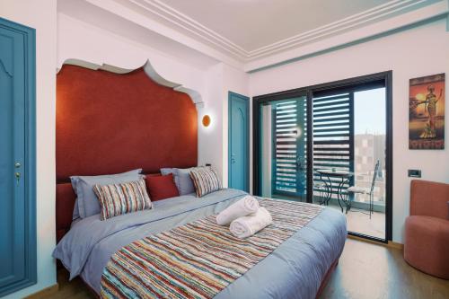 ein Schlafzimmer mit einem großen Bett und einem großen Fenster in der Unterkunft Hyper Centre - Gueliz - Plaza - Zara - Vue Dégagée " Récemment rénové " in Marrakesch
