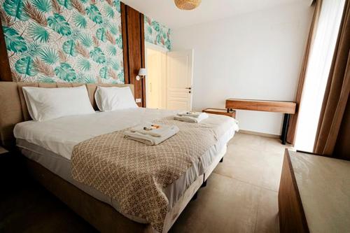 Park Residence 2 في سيغيتو مارماتيي: غرفة نوم عليها سرير وفوط