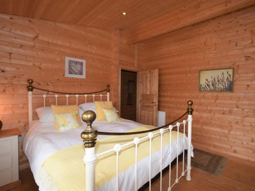 a bedroom with a bed in a log cabin at 4 Bed in Lincoln 59449 