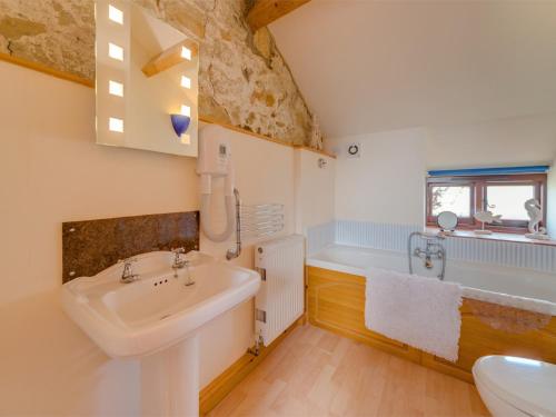 a bathroom with a sink and a bath tub at 2 Bed in Godshill IC129 in Godshill