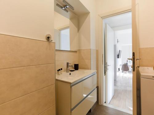 a small bathroom with a sink and a mirror at The Best Rent - Spacious two bedrooms apartment in Porta Romana in Milan