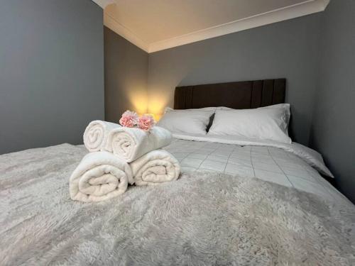 a bedroom with a bed with towels on it at Modern with Stylish Terrace - Your London Oasis! in London