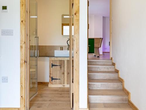 a staircase leading to a bathroom with a shower and a sink at 6 Bed in Cadeleigh 66780 in Cadeleigh