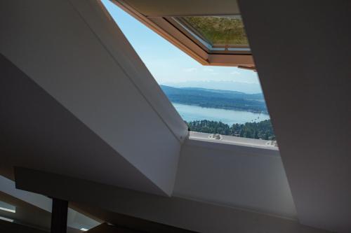 a window in a room with a view of a lake at BnB Belle5 in Bellerive