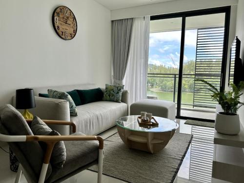 a living room with a couch and a coffee table at 2 bedroom Condo at Cassia Laguna in Bang Tao Beach