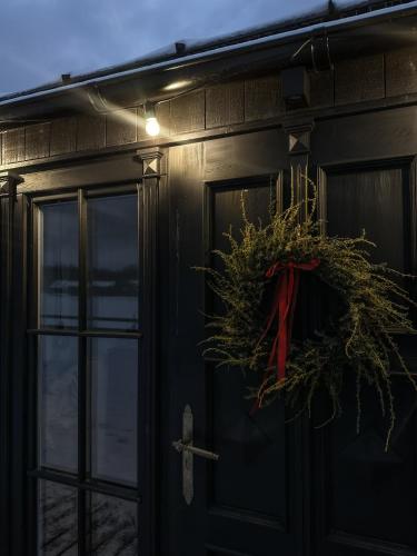a wreath on the door of a house at Ragnar Glamp Pitrags Lux in Pitragutsiyeme