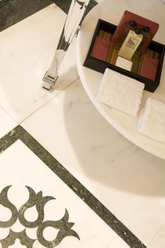 a table with a plate of cosmetics on a floor at Santa Maria Novella - WTB Hotels in Florence