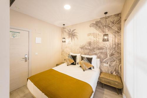 1 dormitorio con 1 cama grande y un mural en la pared en Hostal Plaza Boutique - Solo adultos, en Zaragoza