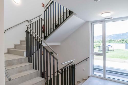 a staircase in a house with a large window at WELCOME 73m2 Ferienwohnung 10 Min. zum Bodensee in Bregenz