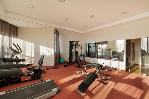 a gym with treadmills and exercise equipment in a room at Elea Beach Hotel in Dassia