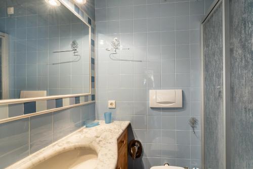 a bathroom with a sink and a mirror at Aurturist Appartement 185 in San Vigilio Di Marebbe