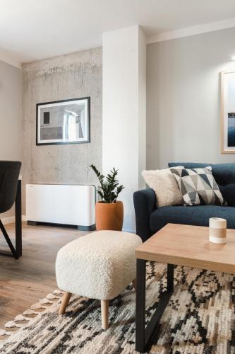 a living room with a couch and a table at 8th Hill Apartments in Plovdiv