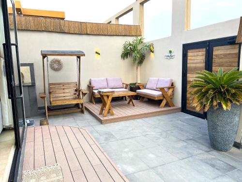 a patio with two chairs and a table at Villa Bali Jeddah in Jeddah