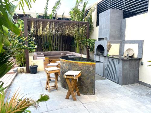 a patio with a bar and an outdoor grill at Villa Bali Jeddah in Jeddah