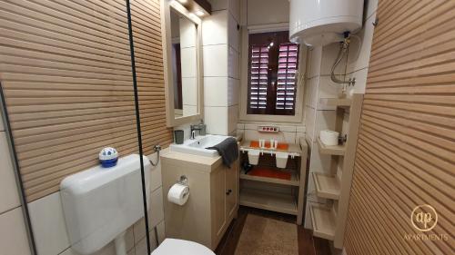 a small bathroom with a toilet and a sink at Studio EMA - Tartini Square in Piran