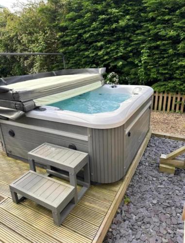 a hot tub sitting on top of a wooden deck at The White Hart in Widworthy