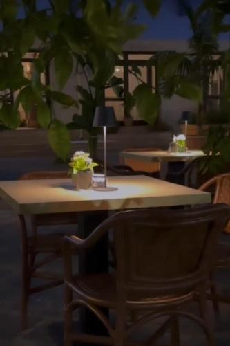 a table and a chair with a plant on it at Hotel Al Faro in Licata