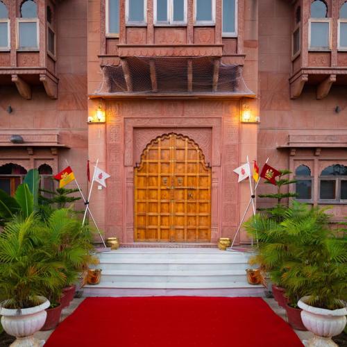 a red carpet in front of a building with a door at Castle Oodeypore A Boutique stay Udaipur in Udaipur