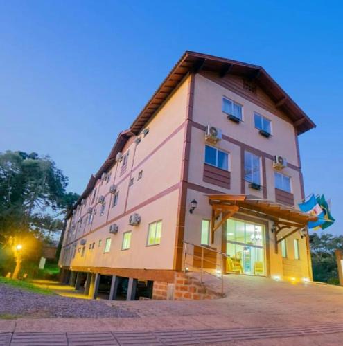 a large pink building with aventh floor at Hotel Serra Canela in Canela