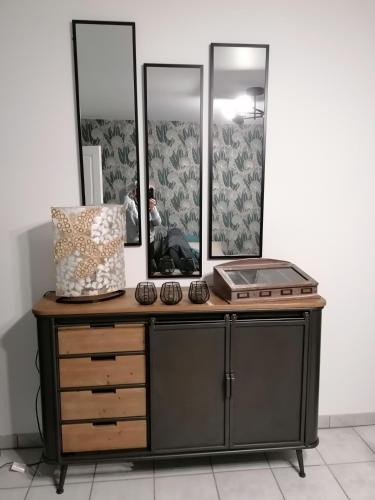 - une commode avec 2 miroirs et un lavabo dans l'établissement La maison Saint-Gervais, à Falaise
