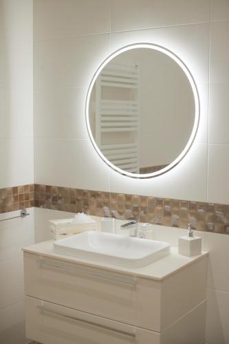 a bathroom with a white sink and a mirror at L'ARTE DI VENERE SUITE in Polignano a Mare