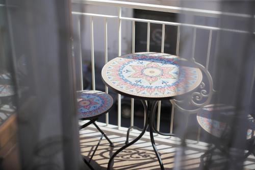 a crib with two chairs and a table in it at L'ARTE DI VENERE SUITE in Polignano a Mare