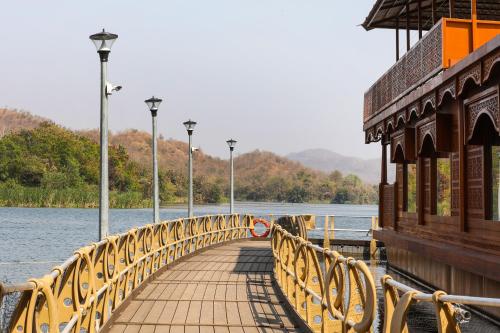 a bridge over a body of water with a building at Ekta Houseboat Statue Of Unity Kevadia in Vadodara