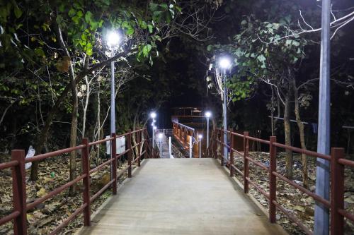 a wooden bridge at night with lights on it at Ekta Houseboat Statue Of Unity Kevadia in Vadodara