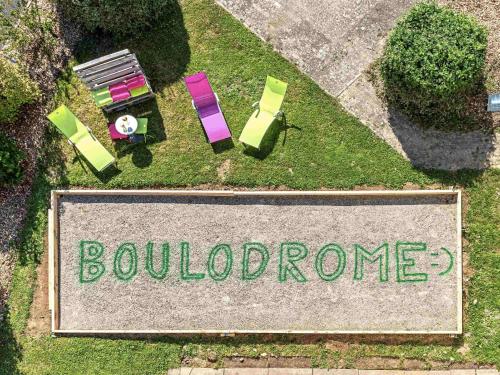 an aerial view of a sign with chairs and tables at ibis budget Strasbourg Sud Illkirch in Geispolsheim