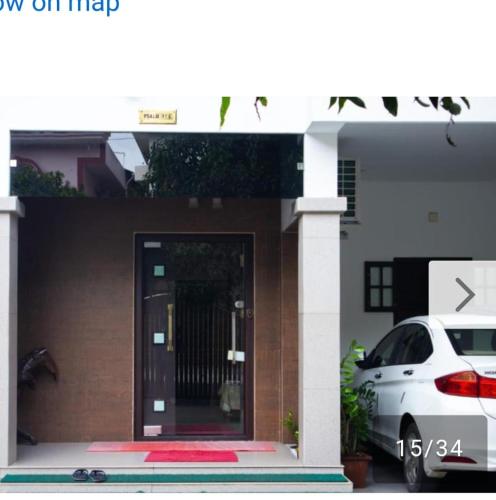 a white car parked in front of a house at Niks homestay B in Trichūr