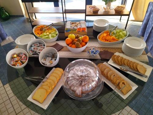 a table with many different types of food on it at Hotel Al Faro in Licata