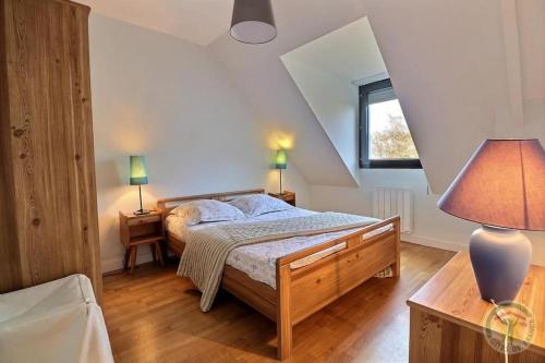 1 dormitorio con 1 cama, 2 lámparas y ventana en Maison Saint LU, en Saint-Lunaire