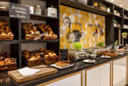 a bakery with lots of bread and pastries on display at Vienna House by Wyndham Andel's Berlin in Berlin