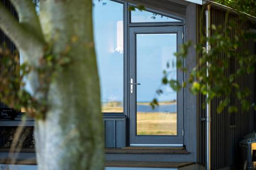 a door leading to a porch with a window at Off Grid Travel at Cambo Estate in St. Andrews