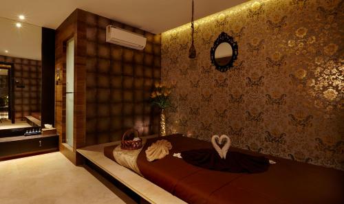 a bedroom with a bed and a mirror on the wall at Mrudgandh Pool Villa Girivan Near Pune Mumbai in Mulshi