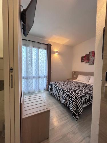 a bedroom with a bed and a window at Affittacamere In Centro in Tortolì