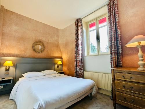 a bedroom with a bed and a window at Château Corneille in Vieux-Villez