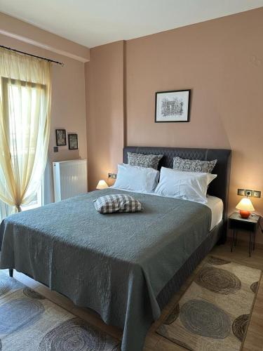 a bedroom with a large bed and a window at Αθανάσιος in Ioannina