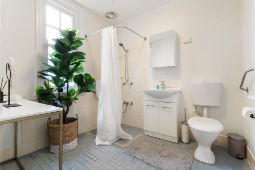 a bathroom with a toilet and a sink and a shower at TWO BEDROOM Apartment in Sydney