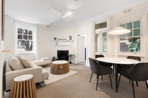 a living room with a couch and a table at Lovely Two Bedroom Apartment in Sydney