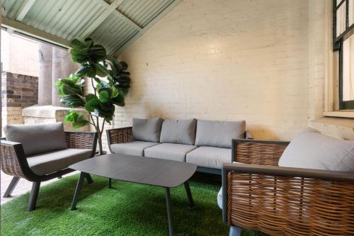 a living room with a couch and chairs at Lovely Two Bedroom Apartment in Sydney