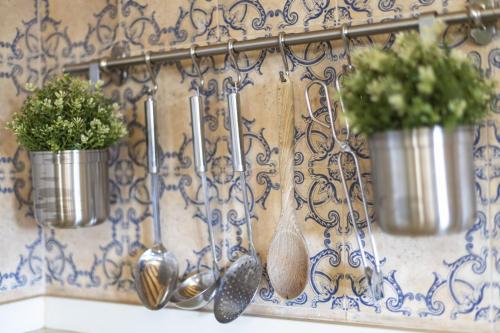 a group of spoons and plants on a wall at Ses Comes in Selva