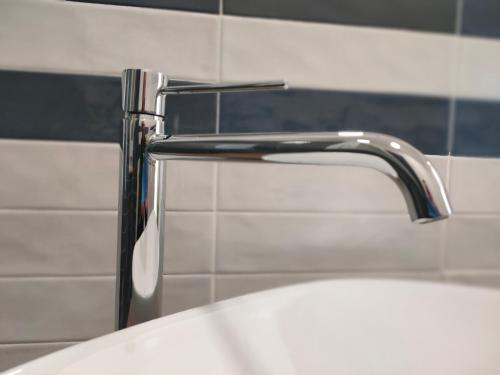 a bathroom sink with a faucet on top of it at Villa Chimera in Pachino