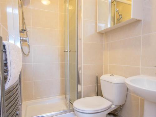 a bathroom with a toilet and a sink and a shower at 2 Bed in Swanage DC192 in Swanage