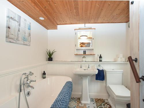 a bathroom with a tub and a toilet and a sink at 1 bed in Spalding 75073 in Surfleet