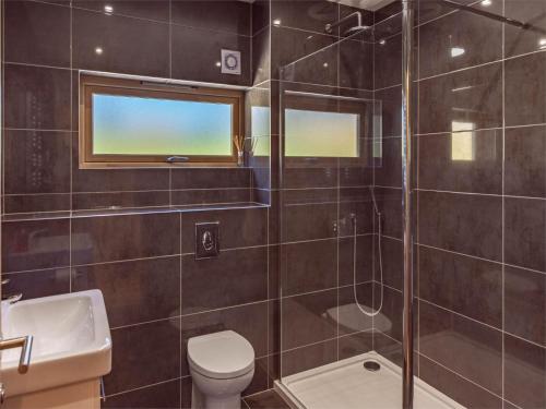 a bathroom with a shower and a toilet and a sink at 4 Bed in Grantown on Spey CA027 in Grantown on Spey