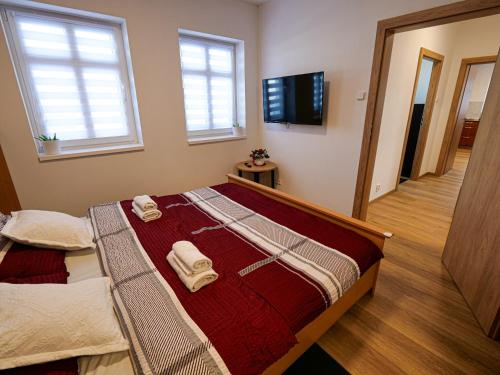 a bedroom with a bed with towels on it at Chaloupka Na Pivovaře Seč in Seč